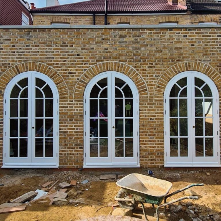 specialised joinery services Arched wooden windows in a yellow brick building in kent